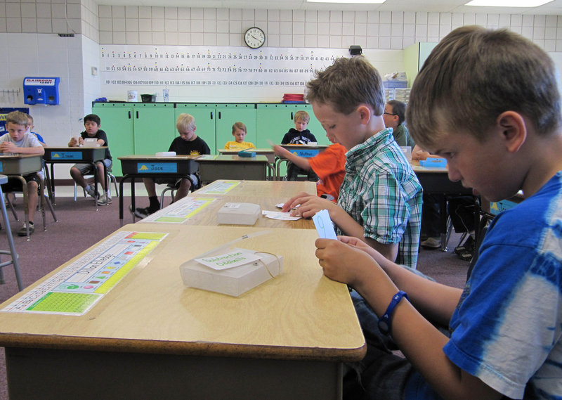Dillon Elledge, 8, right, and Brody Kemble, 7, work with flash cards in their all-boys classroom at Middleton Heights Elementary in Middleton, Idaho, in May. The school originally piloted the idea as a way to address reading problems among boys, but has since expanded the concept.