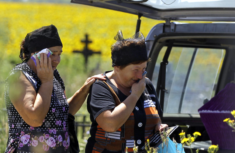 Relatives mourn Monday for Marina Lysenko, one of 171 people who died in weekend flooding in Krymsk, Russia.