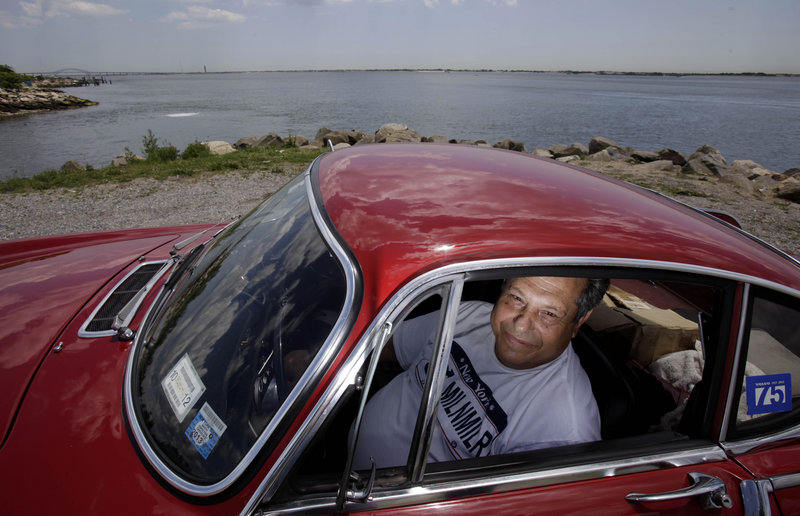 Irvin Gordon sits in his long-lived Volvo P1800S in Babylon, N.Y.