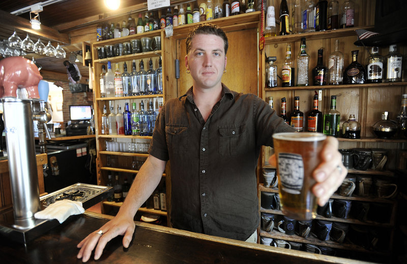 Nat Croteau of Bray’s Brewpub in Naples with a glass of the brewery’s 1492 Summer Ale.