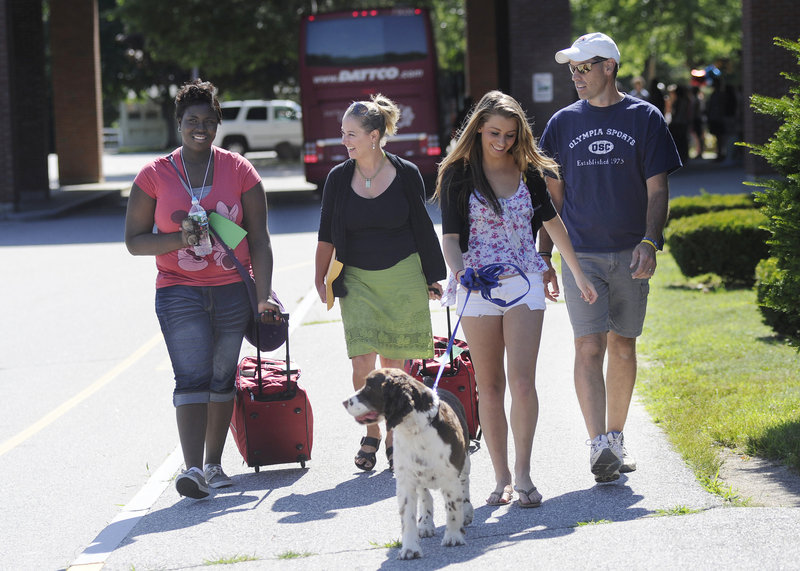 The Dube family – Sheila, Madi and Scott and their dog Baxter – of Dayton walk from the bus with their visitor, Jayla Reid, left. Reid is a returning visitor to Maine and the Dube home.