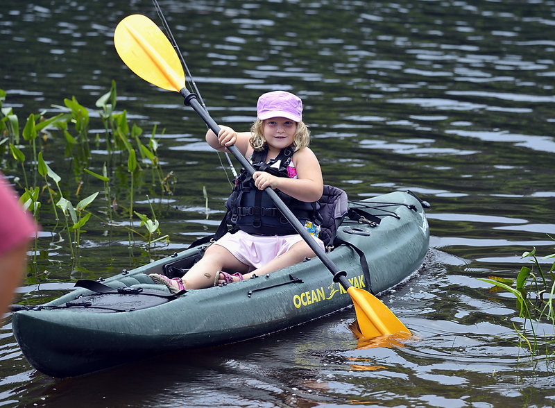 Gabby Walker, 5, of Bath paddles her kayak as she joins other kids participating in last weekend’s tournament.