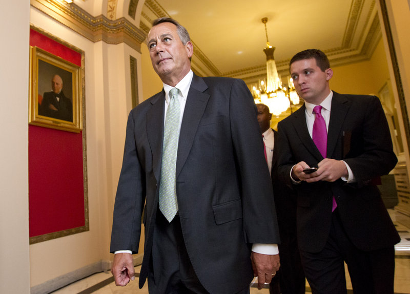 House Speaker John Boehner of Ohio, left, leaves the House chamber Wednesday after the Republican-controlled House voted 244-185 to repeal Obama’s health care law.