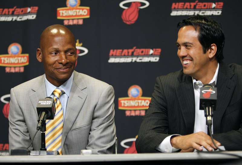 Ray Allen, who left the Celtics after five years to play with the Heat, sits next to Coach Erik Spoelstra during Wednesday’s press conference in Miami. Allen said he will find a way to fit in with the NBA champions.