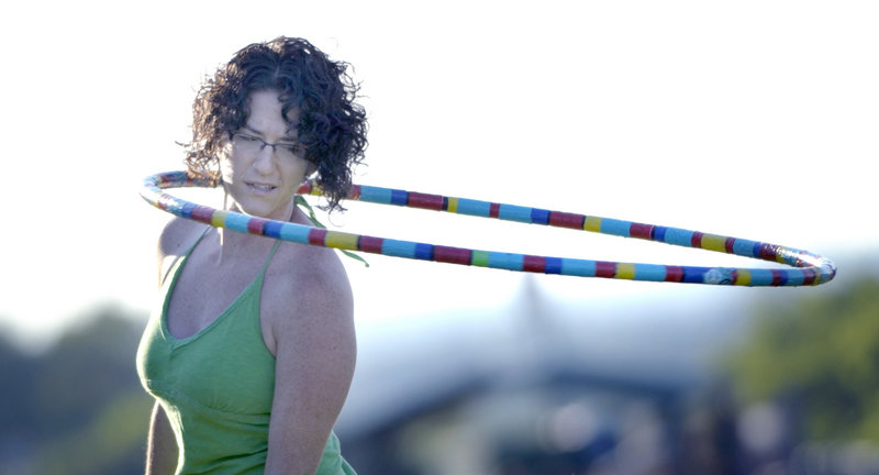 Rachel Schwartz of Portland practices her hula-hoop skills Wednesday evening in a “hoopla” run by Tracy Tingley. The free get-togethers occur weekly on the Eastern Prom in Portland; Schwartz said she participates “because it’s fun!”