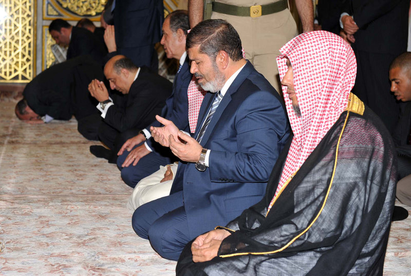 Egyptian President Mohammed Morsi, second from right, prays at the Prophet Mohammed Mosque in Medina, Saudi Arabia, on Thursday.