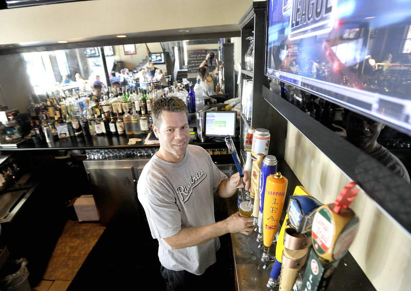 Owner Lance Meader pours a draft at Rivalries, a short walk from the Civic Center in Portland.