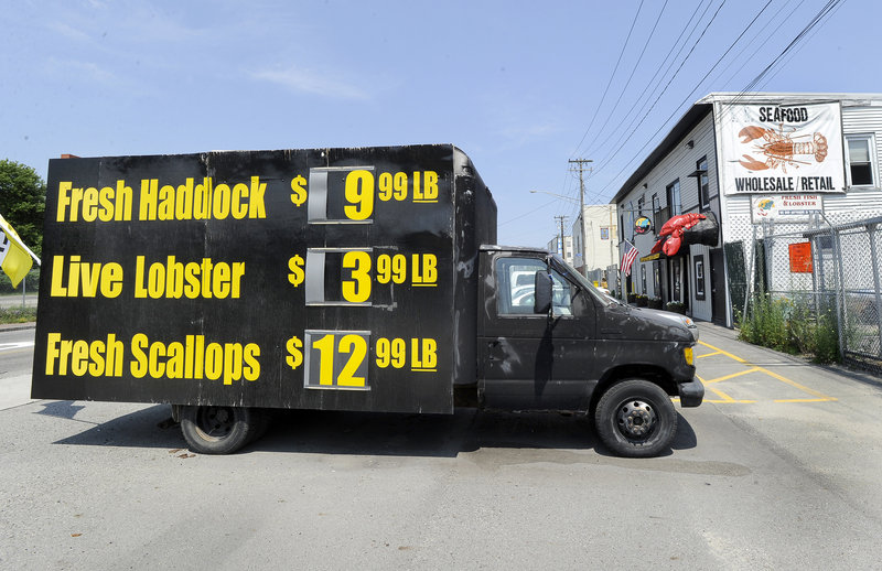 A billboard shows how inexpensive lobsters are at Free Range. On average, lobstermen are getting $3.19 a pound. Soft-shell lobsters came much earlier than normal this year, driven largely by environmental factors, officials said.