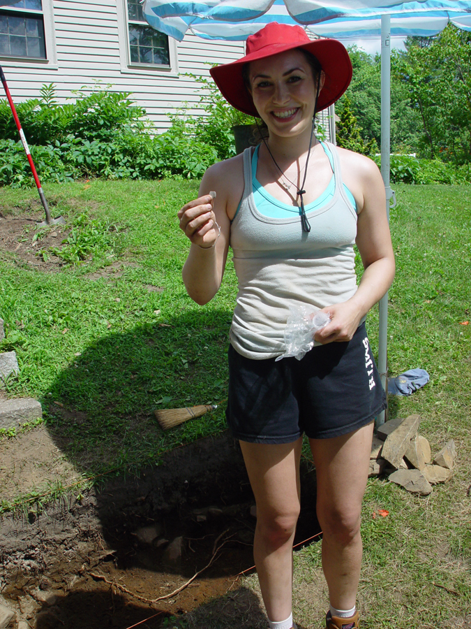 Whitney Parrish, an anthropology student from Portland, holds the Spanish piece of eight she unearthed in South Berwick.