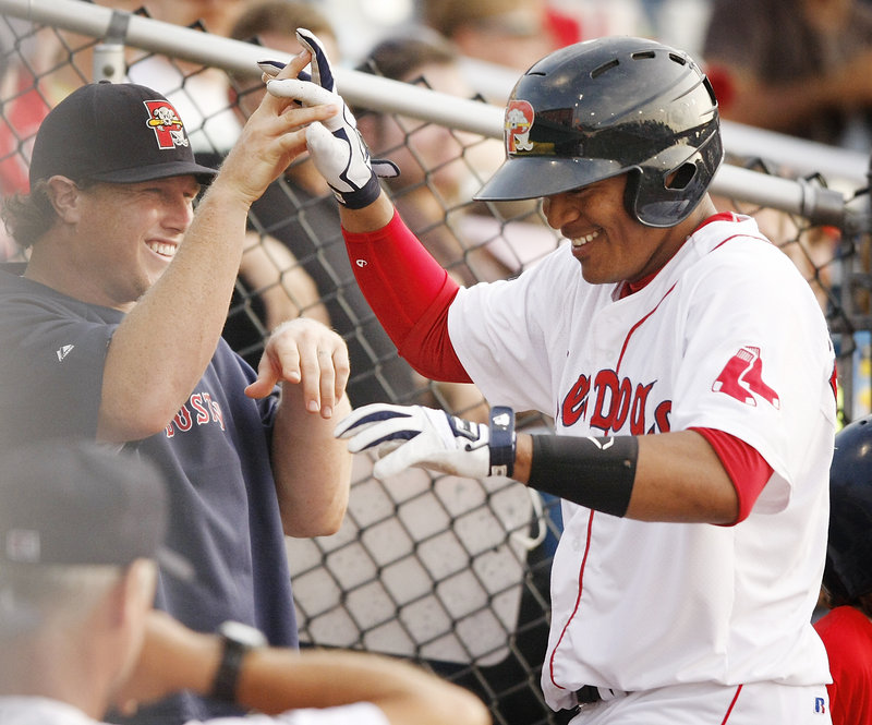 Reynaldo Rodriguez gets congratulated after hitting a two-run homer in the fifth inning Saturday night during the Sea Dogs’ 9-1 win over the Fisher Cats at Hadlock Field.