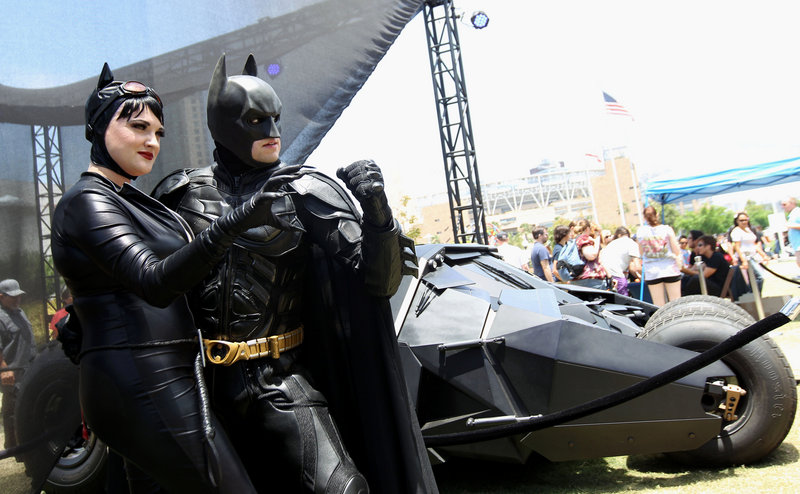 Katie Mitchell and Jonathan Graves of Los Angeles strike a pose in front of the Tumbler Batmobile at Comic-Con in San Diego on Saturday.
