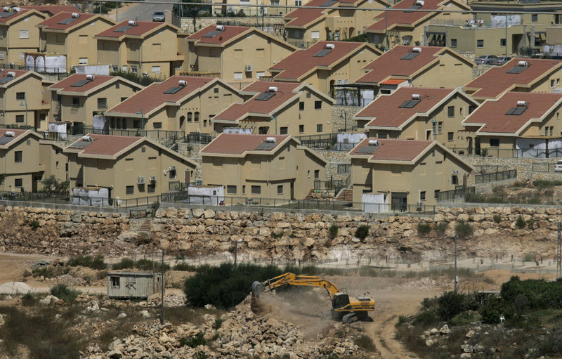 Israeli earth-moving equipment works in a settlement near the West Bank village of Salfit. Israel has agreed to grant subsidies for more than 500 new homes in the West Bank.