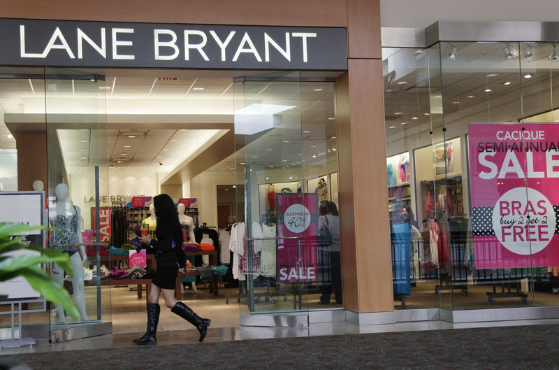 A woman walks into a Lane Bryant store in San Jose, Calif., last month. Americans spent less at retail businesses for a third straight month in June, the Commerce Department reported.