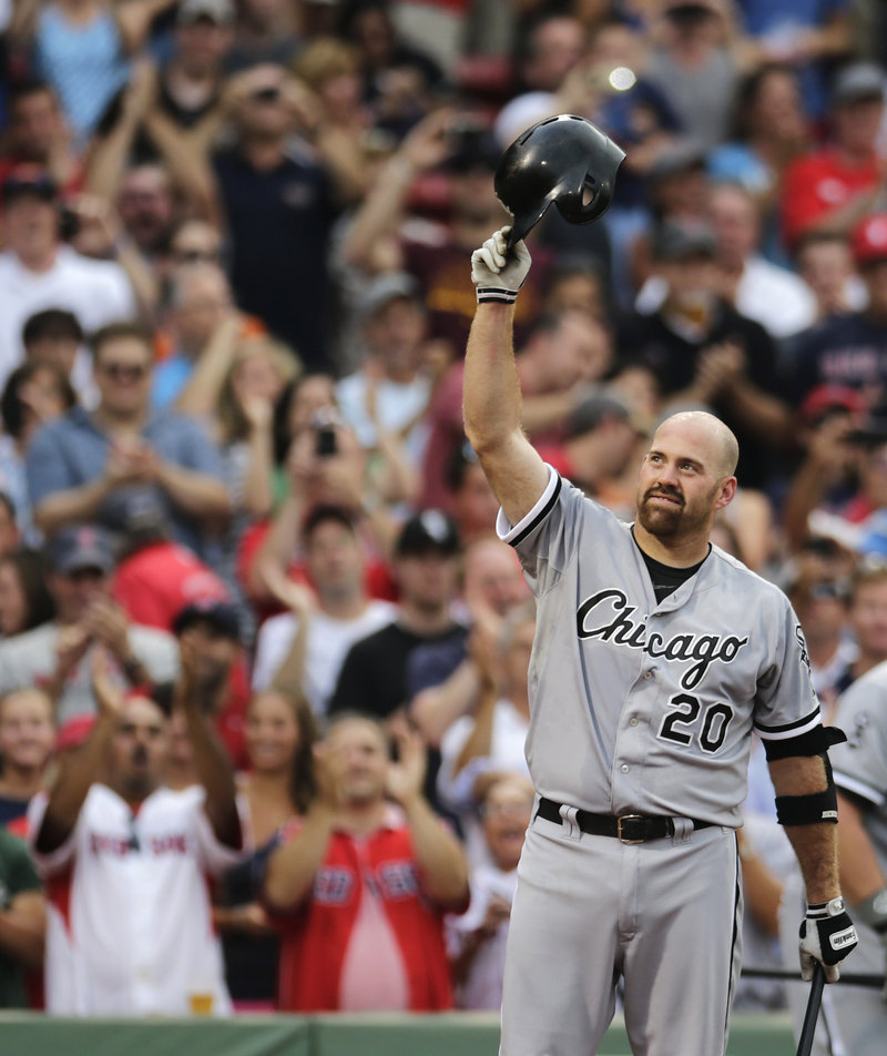 Former Boston All-Star Kevin Youkilis salutes the crowd Monday night, responding to a one-minute standing ovation he received in his return to Fenway Park as a member of the Chicago White Sox.