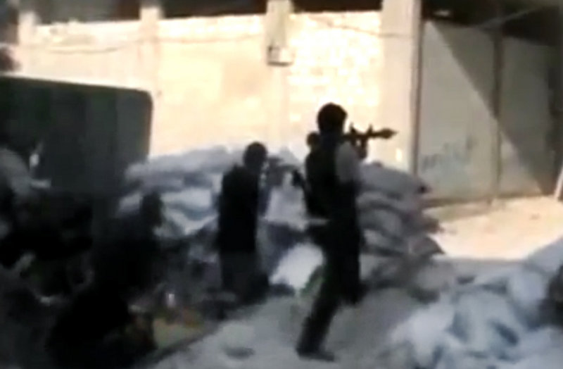 This image made from amateur video accessed Sunday purports to show Free Syrian Army soldiers clashing with Syrian government forces in Damascus.
