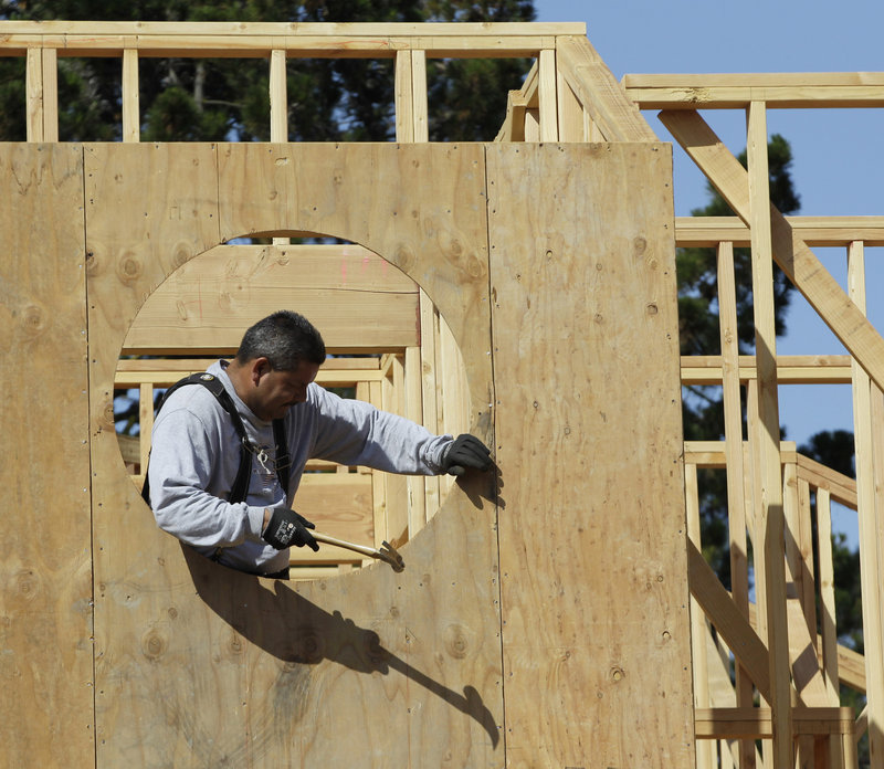 Home builder Mario Sanchez works on a home under construction in Palo Alto, Calif. Confidence among U.S. builders ticked up to a five-year high in June, an indication that the housing market is slowly improving.