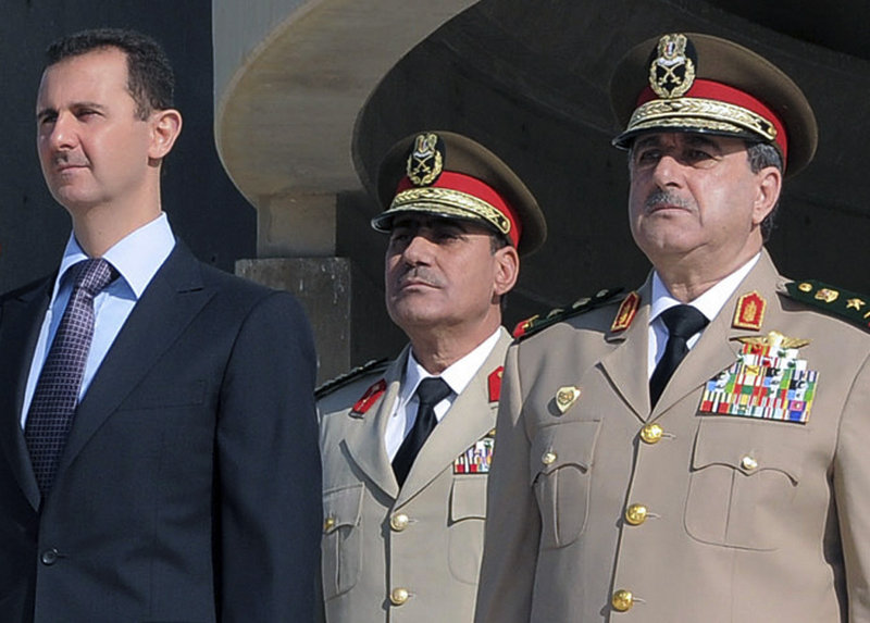 Syrian President Bashar Assad, left, is seen in 2011 with Defense Minister Gen. Dawoud Rajha, right. Rajha was killed Wednesday in a suicide blast inside the National Security building in Damascus, during a meeting of Cabinet ministers.