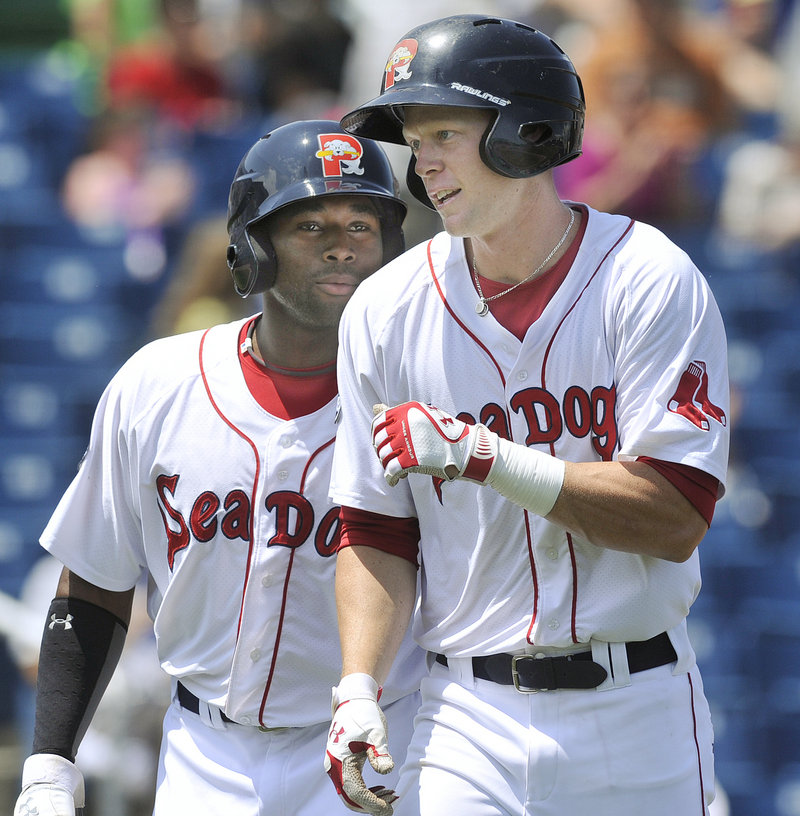 Jeremy Hazelbaker, right, heads back to the dugout with Jackie Bradley Jr. after hitting the first of his two homers Wednesday in the Sea Dogs’ 12-0 win over Reading.