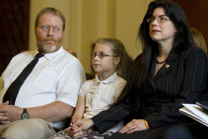 Ruth Moore, right, is accompanied by her husband, Butch Moore, and daughter Samantha on Capitol Hill Wednesday.
