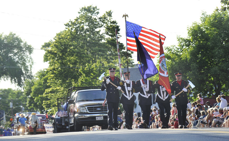 The Yarmouth Fire Department’s color guard leads the annual Clam Festival parade down Main Street in Yarmouth on Friday as the three-day celebration begins. The festival raises funds for about three dozen community, church and school groups.