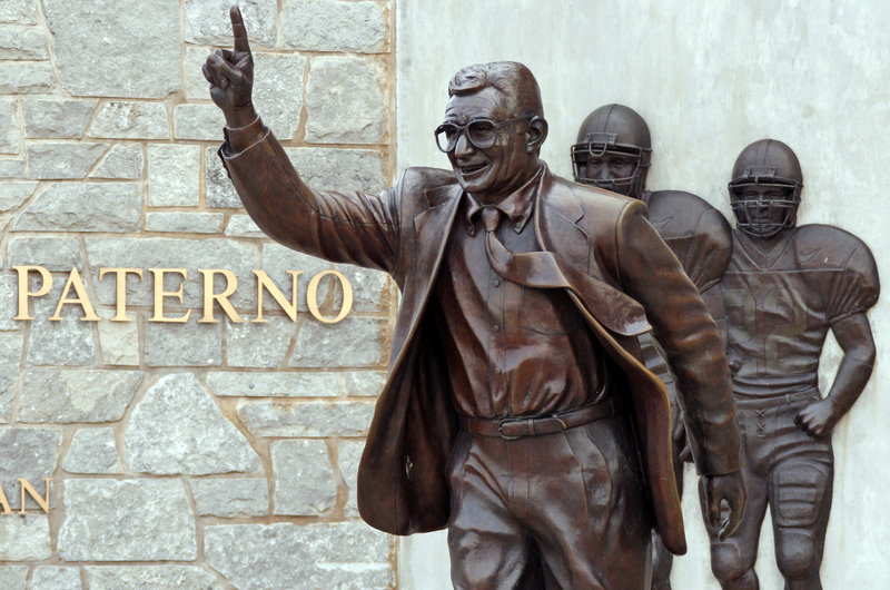 A statue of former Penn State University head football coach Joe Paterno stands outside Beaver Stadium. Questions remain about whether it should come down.