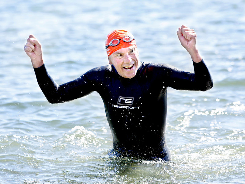 Scott Nelson, 63, of Dover-Foxcroft celebrates Saturday as he approaches the finish of his first Peaks to Portland Swim. His time was 1:12:28.4, good for 201st place.
