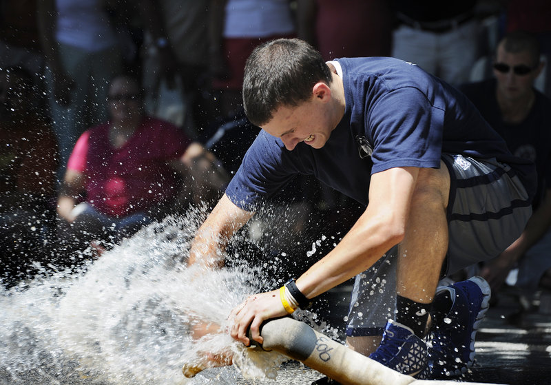 Tyler Woods, a member of the Yarmouth Fire and Rescue team, competes in the Firefighters Muster at the Yarmouth Clam Festival on Saturday.