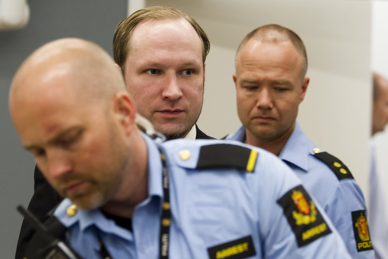 Anders Behring Breivik, center, is escorted to court in Oslo, Norway, on June 22. The confessed killer has said his July 22, 2011, bombing and shooting spree were the opening shots in a war against multiculturalism.