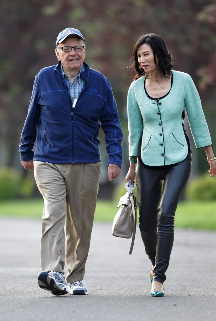 Media mogul Rupert Murdoch and his wife, Wendi, arrive at a conference in Sun Valley, Idaho, earlier this month. He stepped down last week as a director of NI Group, Times Newspaper Holdings and News Corp. Investments in the U.K. It was not immediately clear which of News Corp.’s U.S. boards he has left.