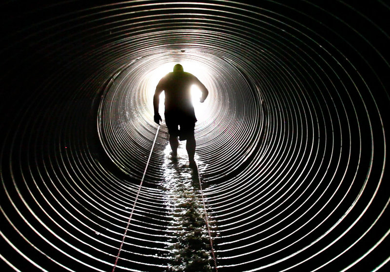 A competitor makes his way through a culvert dubbed the Hole of Horror while competing in the Tough Mountain Challenge at Sunday River in Newry on Saturday. This year’s field was capped at 2,500 competitors – 1,500 more than last year.