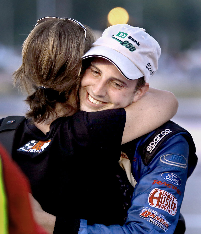 Joey Polewarczyk Jr. hugs his future mother-in-law, Terry Theriault, after winning the TD Bank 250 on Sunday. Theriault’s daughter is engaged to Polewarczyk, and her son, Austin, finished third.