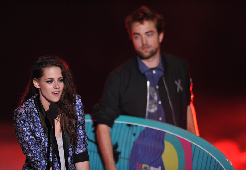 “Twilight” stars Kristen Stewart and Robert Pattinson accept the award for ultimate choice at the Teen Choice Awards on Sunday in Universal City, Calif. The film series has won 41 of the trophies since 2008.