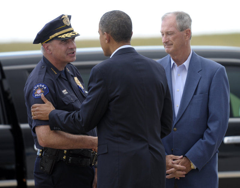 President Obama greets Aurora Police Chief Daniel Oates as Mayor Steve Hogan, right, watches after the president’s arrival at Buckley Air Force Base in Colorado on Sunday.