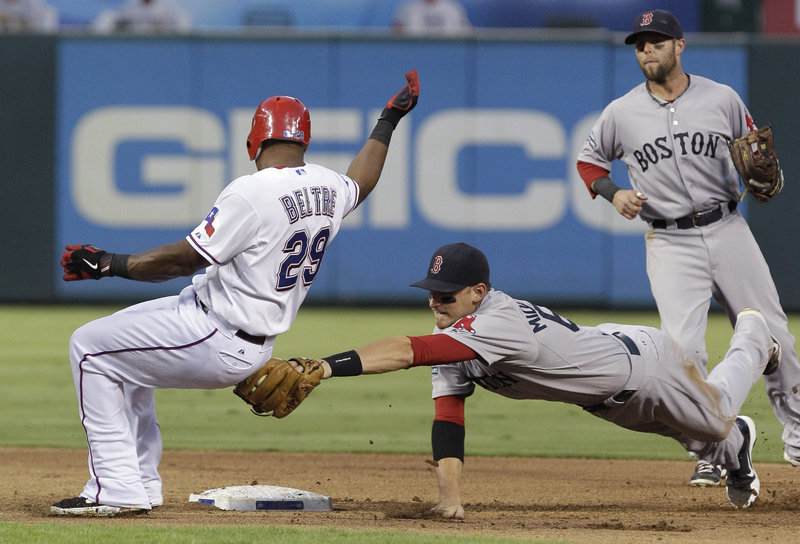 Adrian Beltre of Texas escapes the tag at second by Will Middlebrooks in the fourth inning Tuesday night. Beltre had a double on the play.