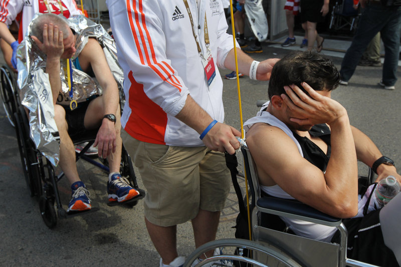 Runners line up in wheelchairs to get inside the medical tent after completing the Boston Marathon on April 16. It was a hot day, and the athletes benefited from lessons learned by doctors at the Beach to Beacon.