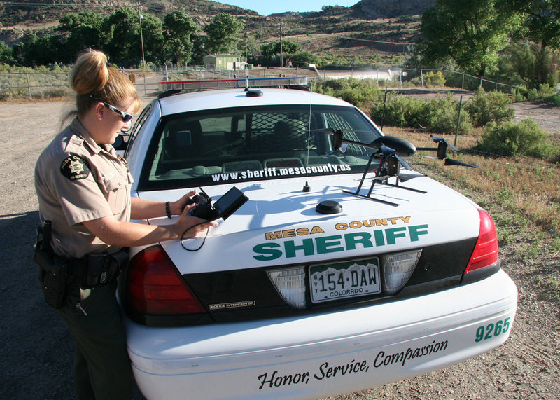 Deputy Amanda Hill of the Mesa County Sheriff’s Office in Colorado prepares to use a Draganflyer X6 drone equipped with a video camera to help search for a suspect in a knife attack.