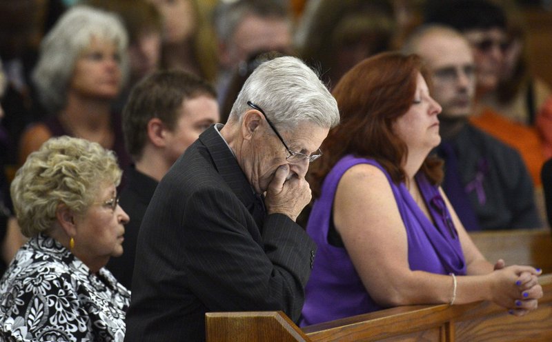Alexander Boik’s mother, Theresa Hoover, right, and family at his funeral in Aurora, Colo., Friday. His was the third funeral in as many days for victims of last week’s deadly shooting.