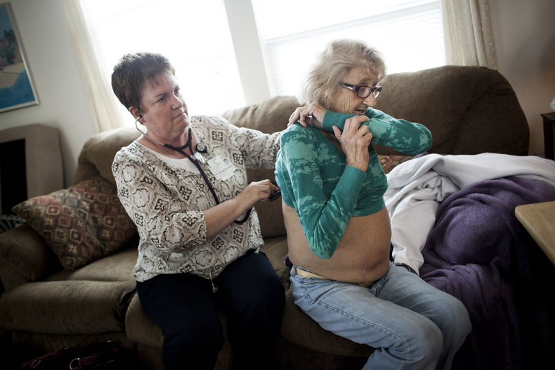 Karen Gossage, a palliative care nurse, listens to the lungs of Marilyn Cronin, 58, of Soquel, Californa, who suffers from emphysema and liver failure, at her home this month.