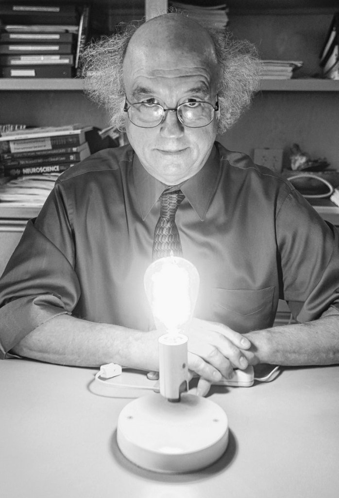 Dr. George Brainard displays an Edison-style incandescent bulb at Thomas Jefferson University, where he researches light’s effects on astronauts and sleep. His new LED lights will have three settings.