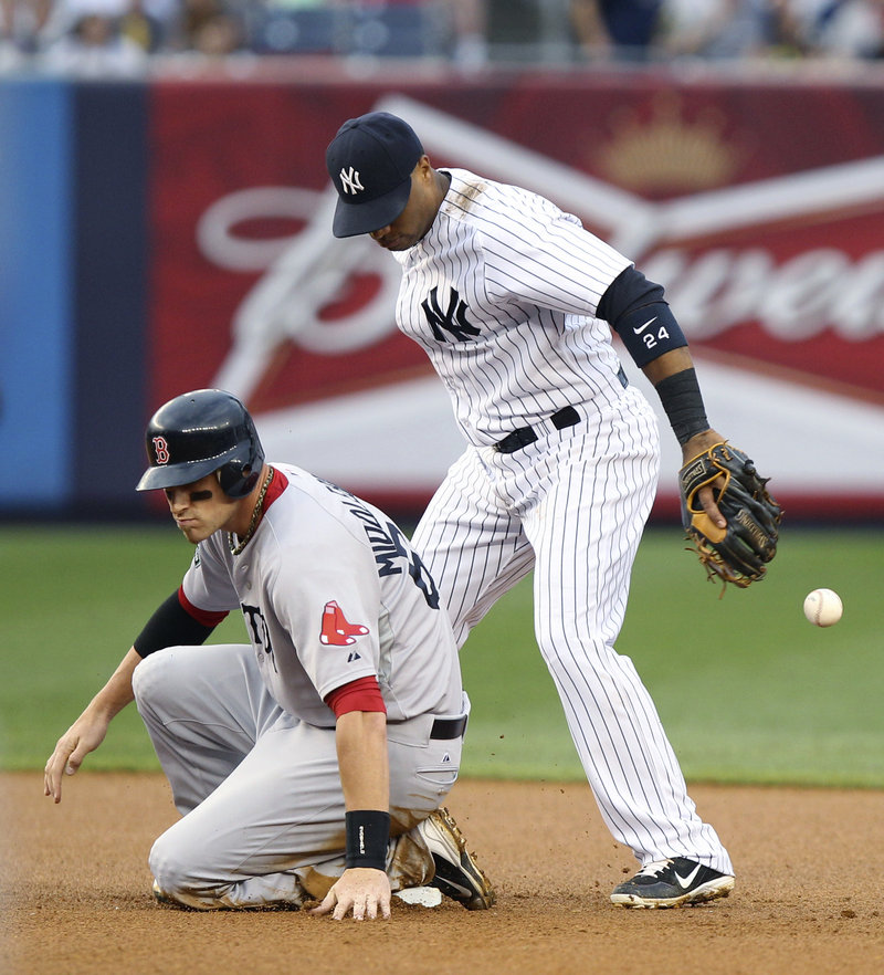 Will Middlebrooks of the Boston Red Sox is safe as second baseman Robinson Cano of the New York Yankees drops the ball Saturday. The Red Sox won, 8-6.