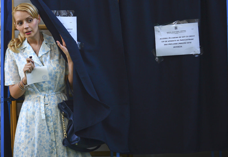 Daciana Sarbu, wife of Romanian Premier Victor Ponta, exits a voting booth in Bucharest during a referendum Sunday on President Traian Basescu’s impeachment. Basescu was accused by his rivals of violating the constitution by overstepping his authority.