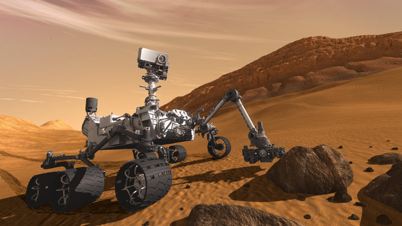 A rendering depicts the rover as if examining a rock. To reach Mars the craft has traveled for 81⁄2 months, covering 352 million miles.