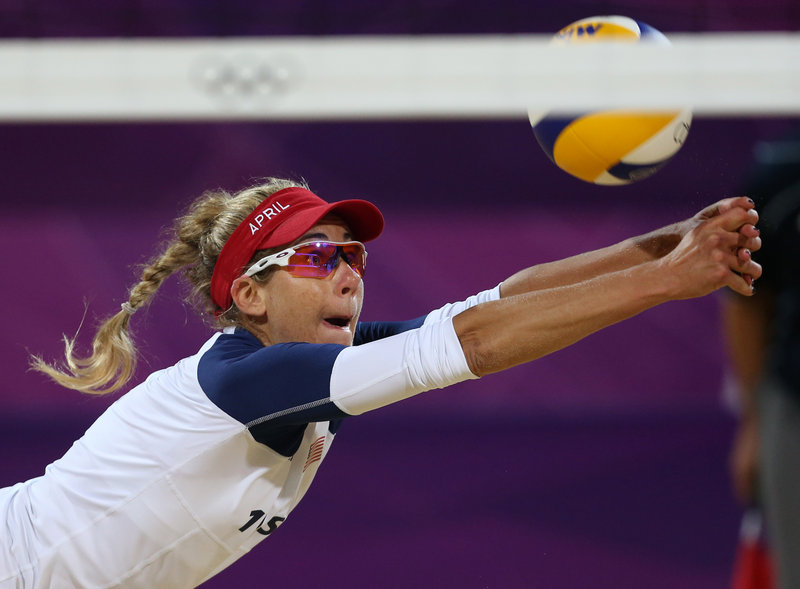 April Ross of the United States stretches for a ball during the three-set beach volleyball victory against the Netherlands. The U.S. men also won, in two sets.