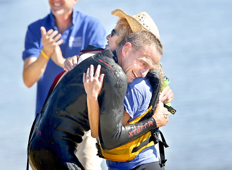 Scott Yeomans of Bethlehem, Pa., embraces his spotter and cousin Beth Ansheles of South Portland after winning the Peaks-to-Portland swim for the second straight year.