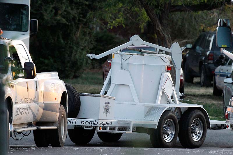 A bomb disposal vehicle arrives near the apartment of alleged gunman James Holmes today in Aurora , Colo. Authorities reported that 12 died and more than three dozen people were shot during an assault at a movie theatre midnight premiere of "The Dark Knight Rises" early Friday.