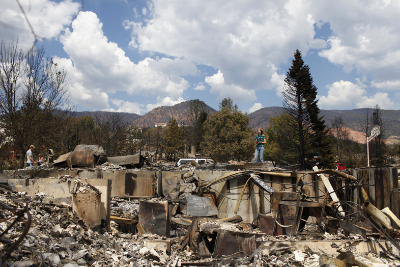 Krista Albers surveys what is left of her home Sunday in the Mountain Shadows subdivision of Colorado Springs, Colo., after the Waldo Canyon fire ravaged the neighborhood.