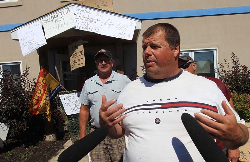 FRUSTRATED FISHERMEN: Over two hundred lobster fishermen converge on the office of Federal fisheries minister Keith Ashfield on Wednesday. Fisherman Maurice Martin, right, speaks with media after he and four other fishermen met with staff in Ashfield's office.