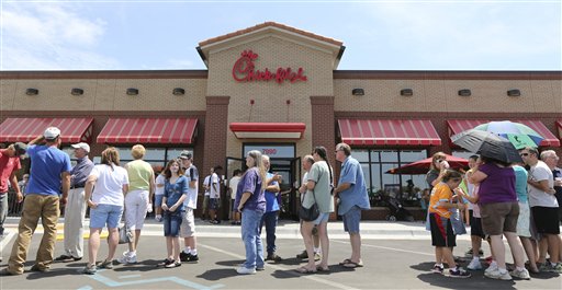 Customers stand in line for a Chick-fil-a meal at the chain's restaurant in Wichita, Kan., on Wednesday. Aug. 1, 2012. The crowd was buying meals to show their support for the company that's currently embroiled in a controversy over same-sex marriage. Former Arkansas Gov. Mike Huckabee, a Baptist minister, declared Wednesday national "Chick-fil-A Appreciation Day." Opponents of the company's stance are planning "Kiss Mor Chiks" for Friday, when they are encouraging people of the same sex to show up at Chick-fil-A restaurants around the country and kiss each other. (AP Photo/The Wichita Eagle, Travis Heying)