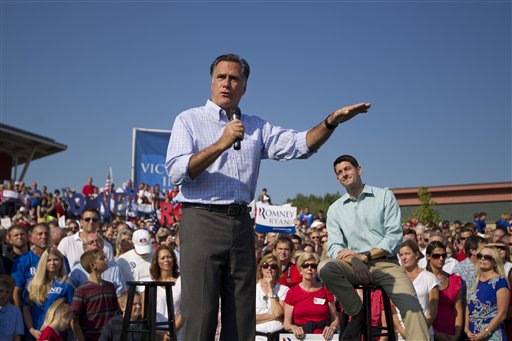 In this Aug. 25, 2012, photo, Republican presidential candidate, former Massachusetts Gov. Mitt Romney speaks as vice presidential running mate Rep. Paul Ryan, R-Wis., listens during a campaign rally in Powell, Ohio. Romney and Ryan are the political world�s newest odd couple. They�re bound by substance, but dramatically different in their styles. The running mates share a love of policy, and a fascination with the world�s economy and America�s place in it. But where Romney is buttoned-up and reserved on the campaign trail, Ryan is relaxed and exudes a natural enthusiasm. (AP Photo/Evan Vucci)