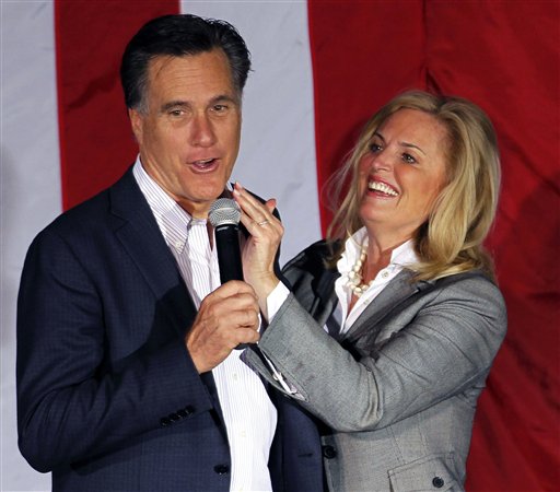 FILE - In this March 5, 2012, file photo, Ann Romney, wife of Republican presidential candidate, former Massachusetts Gov. Mitt Romney, wipes lipstick off his face after kissing him at a campaign rally in Zanesville, Ohio. To the yearbook editors at the all-girl Kingswood School Davies' destiny seemed pretty obvious. "The first lady," the entry beside the stunning blond beauty's photo in the 1967 edition of "Woodwinds" concluded. "Quiet and soft spoken." The modern feminist movement was just dawning, and even some of the girls at the staid prep school in the wealthy Detroit suburb of Bloomfield Hills were feeling their oats _ if in a somewhat tame way. Charlon McMath Hibbard remembers getting a doctor's note about her feet, so she wouldn't have to wear the obligatory saddle Oxfords. (AP Photo/Gerald Herbert, File)